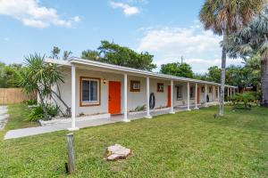 a building with orange and white paint on it at Beach Bungalow By The Sea 1 in Cocoa Beach