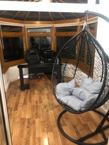 a hanging hammock with pillows in a living room at Cozzy Living in Killingbeck