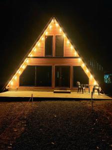 a house with two chairs in front of it at night at Cabana Arunia 