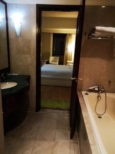a bathroom with a bath tub and a sink and a bath tub at Crown Apartment at Times Square in Kuala Lumpur