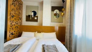 a bedroom with a bed with white sheets at Résidence avec piscine Agadir in Agadir +15 photos