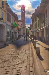 a rendering of a cobblestone street with a clock tower at Rho appartamento in centro in Rho