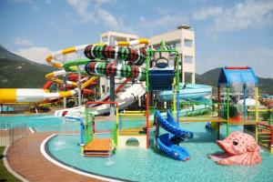 a water park with a water slide in the water at Gold City 5 star resort 2+1 appartement sea view and aqua park in Alanya