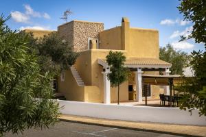 a house in the middle of a street at CAN NOVES - Villas de 4 suites 52 y 35 in Sant Francesc Xavier