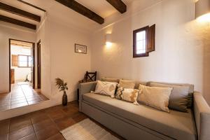 a living room with a couch and a window at CAN NOVES - Villas de 4 suites 52 y 35 in Sant Francesc Xavier