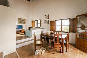 a kitchen and dining room with a table and chairs at CAN NOVES - Villas de 4 suites 52 y 35 in Sant Francesc Xavier