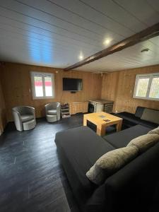 a room with a bed and a table and chairs at Maison de campagne avec piscine in Courbouzon