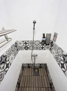 a bathroom with black and white tiles on the floor at Kenting Original Hostel in Kenting