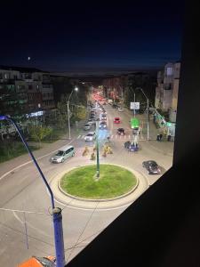 a busy city street at night with cars on the road at NEW APARTAMENT in Drobeta-Turnu Severin