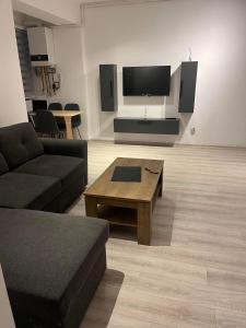 a living room with a couch and a coffee table at NEW APARTAMENT in Drobeta-Turnu Severin