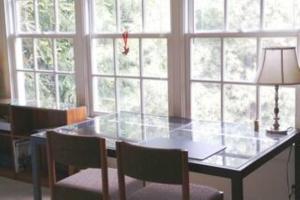 a table with chairs and a lamp in a room with windows at Free Parking on a Private St., Minutes to Georgetown, MedStar Hospital, Georgetown University and more in Washington