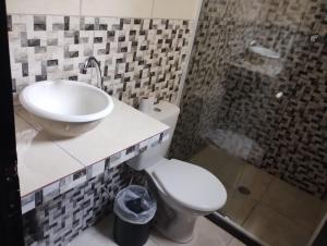 a bathroom with a sink and a toilet and a shower at Hotel Real Centro in Sao Paulo