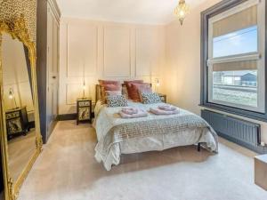 a bedroom with a bed and a large window at Dreamy home in the heart of Whitstable in Kent