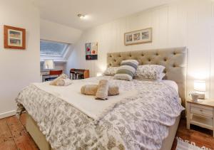 a bedroom with a large bed with two pillows on it at The Counting House in Fowey