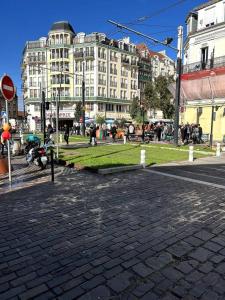 a cobblestone street in a city with tall buildings at Appartement proche de PARIS au centre ville tout confort in Livry-Gargan