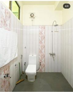 a bathroom with a shower and a toilet in it at Olivehomestay in Kohīma