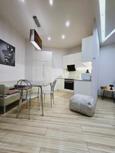 a kitchen and dining room with a table and chairs at Most City Kos in Dnipro