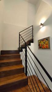 a staircase in a house with a picture on the wall at GIO&GIO central house in Palermo