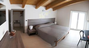 a bedroom with a bed and a table in a room at B&B Alba in Langhe in Verduno