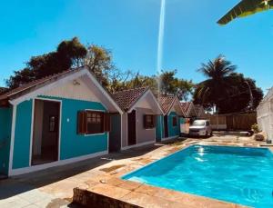 a house with a swimming pool in front of it at Pousada do Sol in Rio de Janeiro