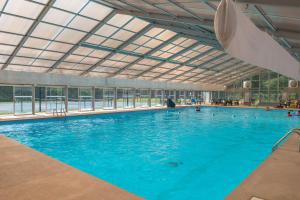 a large pool with blue water in a building at Copper Lantern in Ellijay