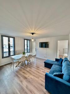 a living room with a blue couch and a table at Magnifique apartment in Paris / Bagnolet 101 in Bagnolet
