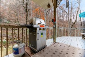 an outdoor grill on a deck with a fence at 2 Bed 2 Bath Vacation home in Whittier I in Whittier