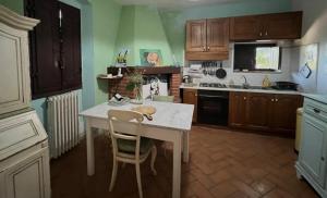una cocina con mesa blanca y sillas. en Spacious house with private garden in Chianti, en Lucolena in Chianti