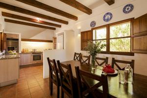 a kitchen and dining room with a table and chairs at CAN NOVES - Villa de 5 suites 15-58 in Sant Francesc Xavier