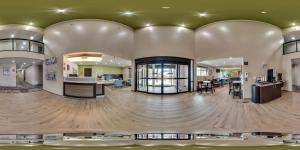 a large lobby with a wooden floor and a building at Sleep Inn Madison in Madison
