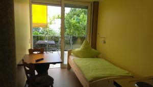 a room with a bed and a table and a window at Humboldtruh in Weitersburg