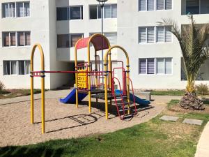 a playground in front of a building at Hermoso Jardines del Pacifico in La Serena