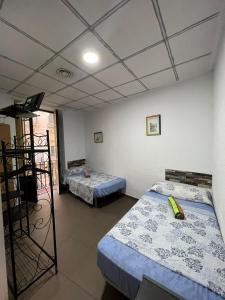 a room with two beds and a ladder in it at Hostal Milan in Alicante