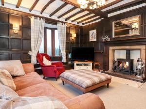a living room with a couch and a fireplace at Grey Walls in Penrith