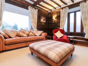 a living room with a couch and a chair at Grey Walls in Penrith