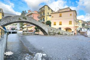 an old bridge over a river in a city at PIEDS DANS L'EAU in Bogliasco