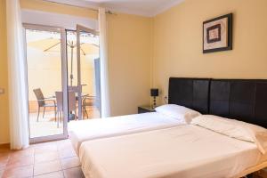 Posteľ alebo postele v izbe v ubytovaní Villas y Apartamentos El Sultan