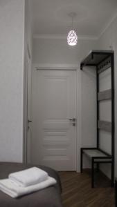 a bedroom with a bed and a door and a ladder at Gallery Elit Hotel in Dunaivtsi