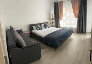 a bedroom with a bed and a chair at Deea H24 in Râşnov