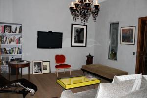 a living room with a couch and a tv at Luxury two bedroom apartment in Apt, the heart of the Luberon in Apt