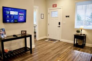 a living room with a flat screen tv on the wall at ZC2 Home Base for Zion With Two Masters in La Verkin +18 photos