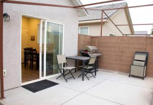 a patio with a table and chairs and a grill at ZC2 Home Base for Zion With Two Masters in La Verkin