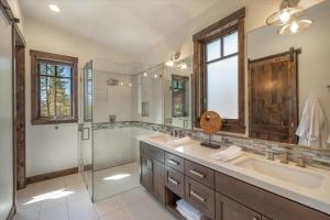 a bathroom with a shower and a sink and a mirror at Lavish 4 BR in Gray's Crossing in Truckee +18 photos
