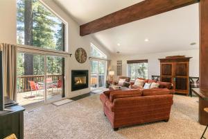 a living room with a couch and a fireplace at Wolf Den - Bright Open Concept 3 Bedroom- Hot Tub, Pet-Friendly, Minutes from Skiing! in Tahoma