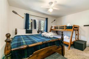 a bedroom with a bed and a bunk bed at Wolf Den - Bright Open Concept 3 Bedroom- Hot Tub, Pet-Friendly, Minutes from Skiing! in Tahoma
