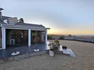 a house with a patio with a view of the ocean at The Dutch Corner house in Langebaan