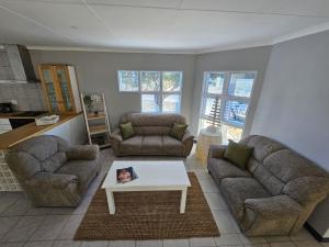 a living room with two couches and a coffee table at The Dutch Corner house in Langebaan