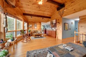 a large living room with wooden ceilings and a kitchen at Spacious Finger Lakes Home with Mountain Views 
