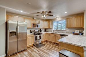 una cocina con nevera de acero inoxidable y armarios de madera en Close to Denver & Golden - Perfect for Groups, en Arvada