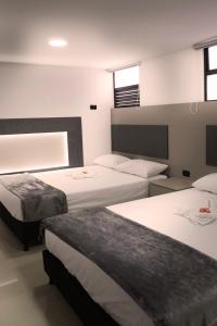 Postel nebo postele na pokoji v ubytování ApartaHotel Estadio